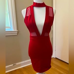 Red cocktail dress with plunge neck and some red sheer panels